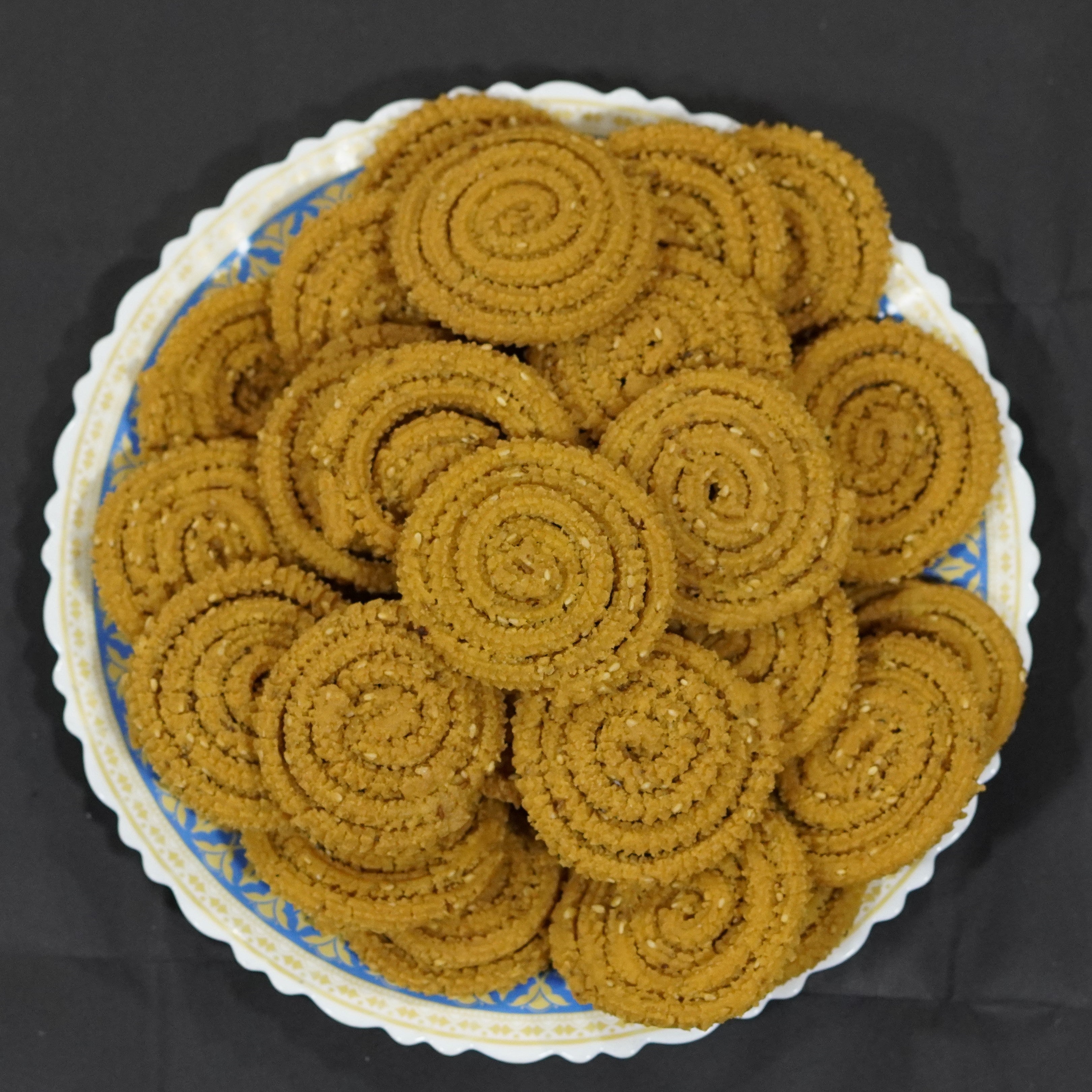 Homemade Maharashtrian chakali piled on a plate